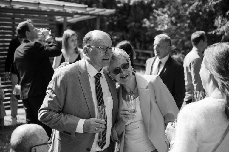 Web-72 Schwarz-Weiß-Foto: Gäste im Gespräch vor dem Standesamt – Standesamt Renée & Patrick